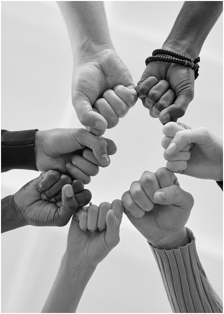 A group of hands joining together